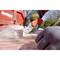 A person is cutting plastic with a craft knife on a red container. Protective clothing and gloves are being worn.