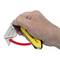 A hand holds a yellow Stanley FatMax knife. A red arrow animation shows how the blade is safely folded away.