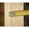 A yellow tape measure is placed against a wooden board. It shows a length of approximately 56 millimetres.