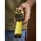 A person is holding a tape measure with a yellow scale in their hand, ready to take a measurement.