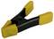 A yellow plastic clip with a black handle.