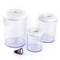 Three transparent plastic containers with white lids in various sizes, alongside a small purple sealing stopper.