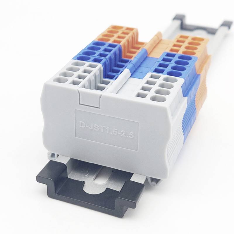 A multi-pole connector in grey, blue and orange, mounted on a DIN rail. Suitable for electrical wiring.