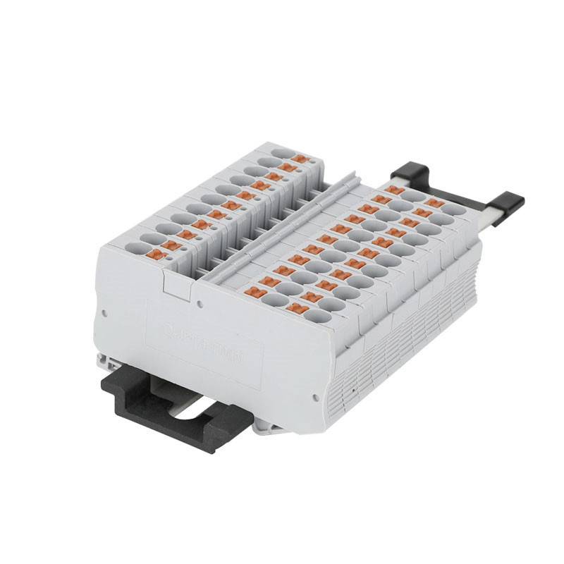 A grey electrical terminal block with multiple connection options, black mounting fastening on the underside.