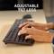 Two hands typing on a computer keyboard. The text 'Adjustable Keyboard Feet' indicates a feature of the keyboard.