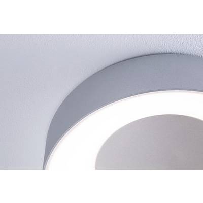 A round, contemporary ceiling light casts soft light onto a white ceiling, creating a soothing atmosphere.