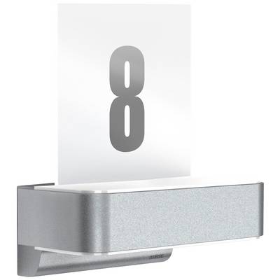 Metallic door number plate with a large, grey '8' on a transparent background, mounted on the wall.