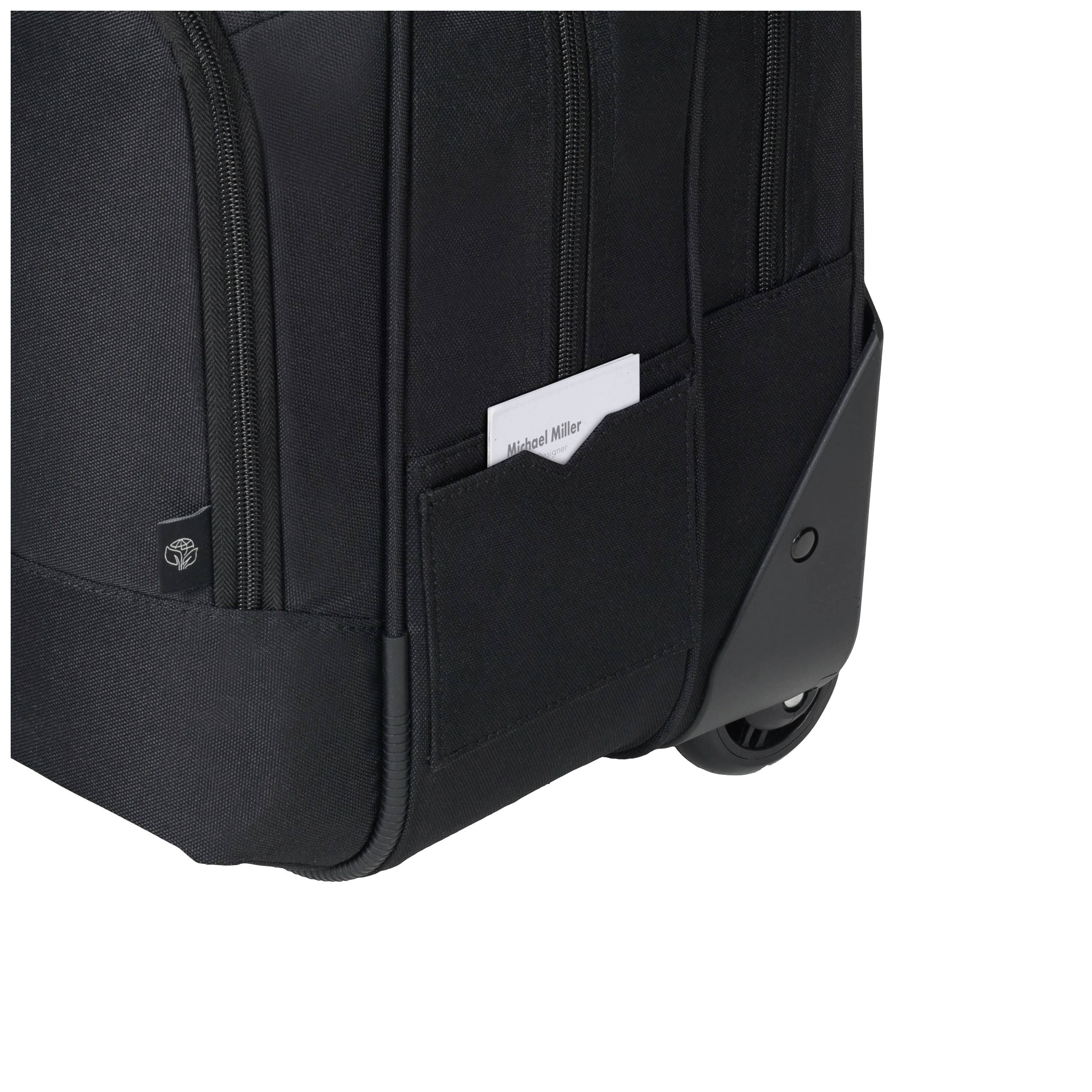 Suitcase with wheels and multiple zip compartments, black in colour. A business card is tucked into one of the side pockets.