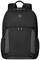A black rucksack with grey details stands upright. It has a distinctive logo badge on the upper front and multiple pockets.