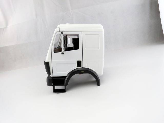 A white model lorry cab without wheels, displayed against a neutral background.