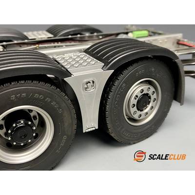 Close-up of a model lorry chassis with two black tyres and silver rims. A 'ScaleClub' logo is visible in the background.