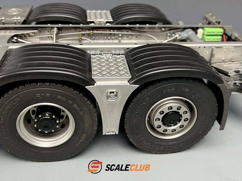 'Close-up of a model lorry with two axles, tyre markings and the Scale Club logo on a grey background.'