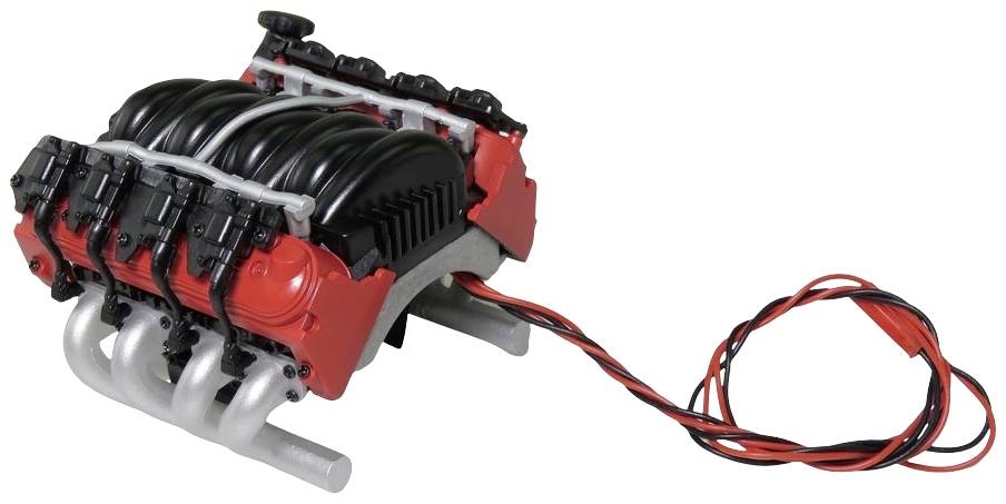 A red, plastic-like toy motor with black details. Red and black wires are hanging from the right side.