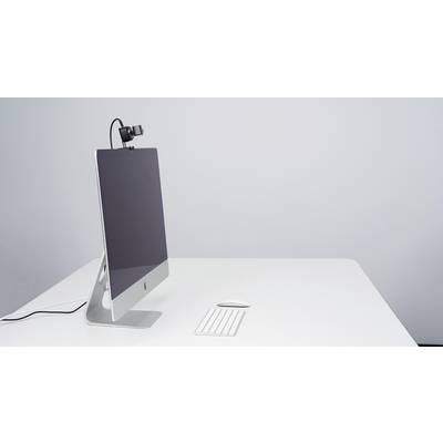 A modern computer with a monitor, keyboard and mouse on a white desk. A webcam is mounted at the top of the monitor.