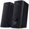 Two black GX Trust speakers with LED lighting on the underside and a volume control on the front.