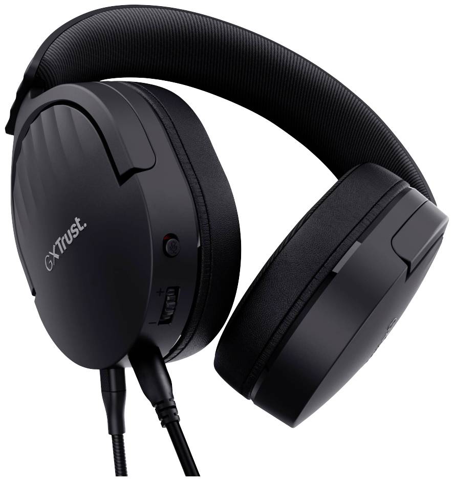 A black over-ear headphone with padding and cable, showing the Trust brand on the side, features volume controls and a microphone socket.