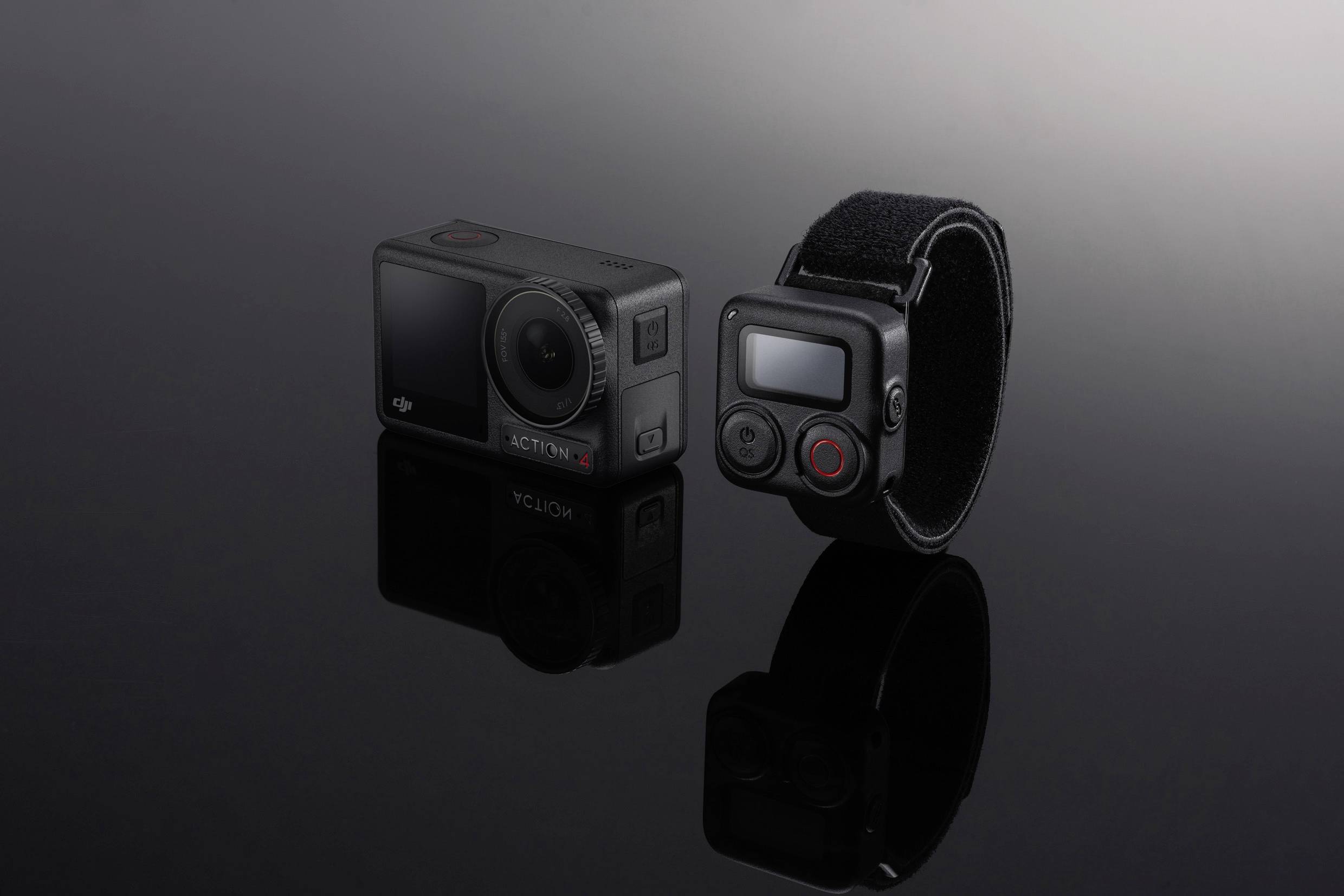 Two compact action cameras, one with a wristband, on a black background. Suitable for sporting activities and capturing motion.