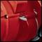Close-up of a red engineering component with a silver screw and a lever. Dominant red and metallic tones.