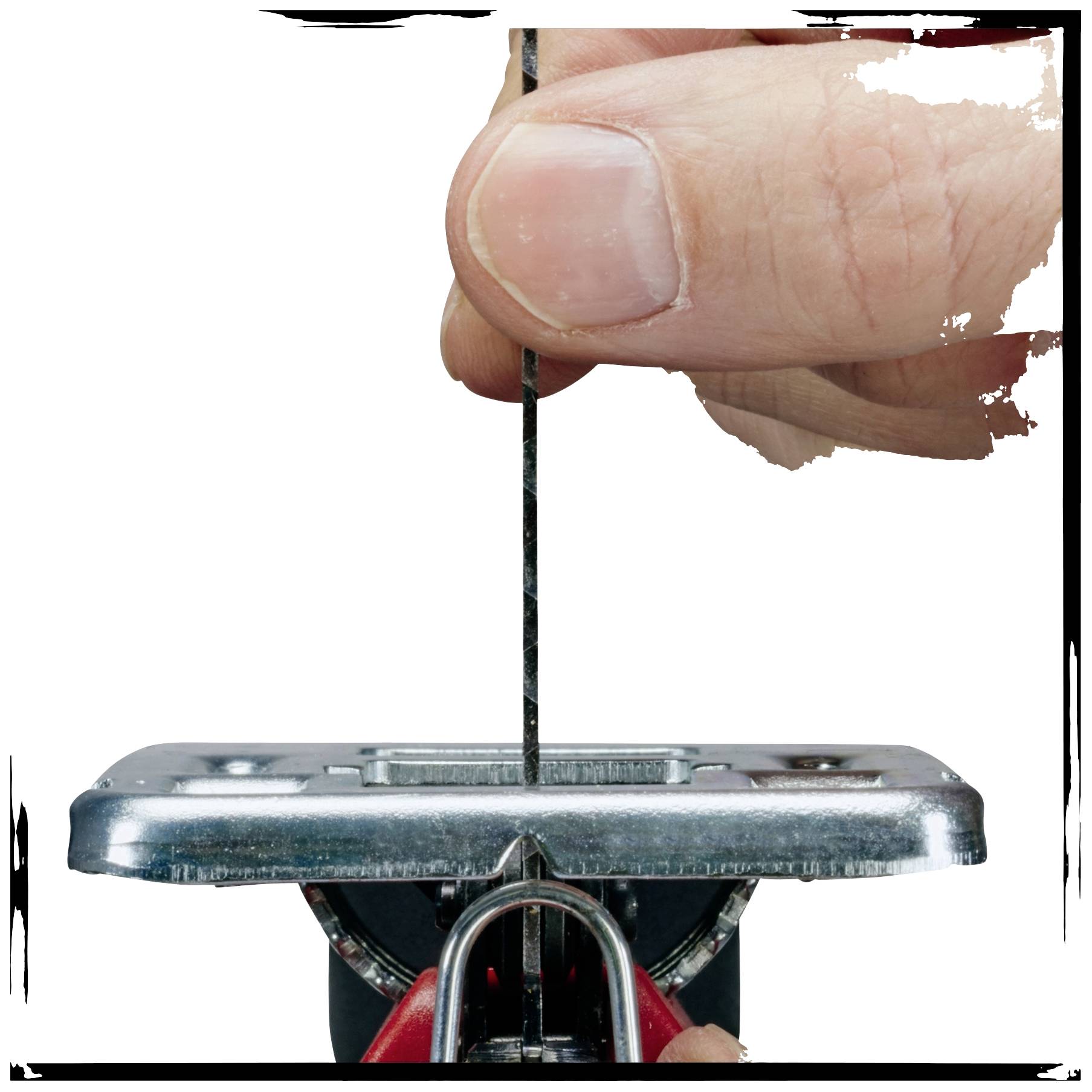 Close-up of a finger inserting a saw blade into a jigsaw.
