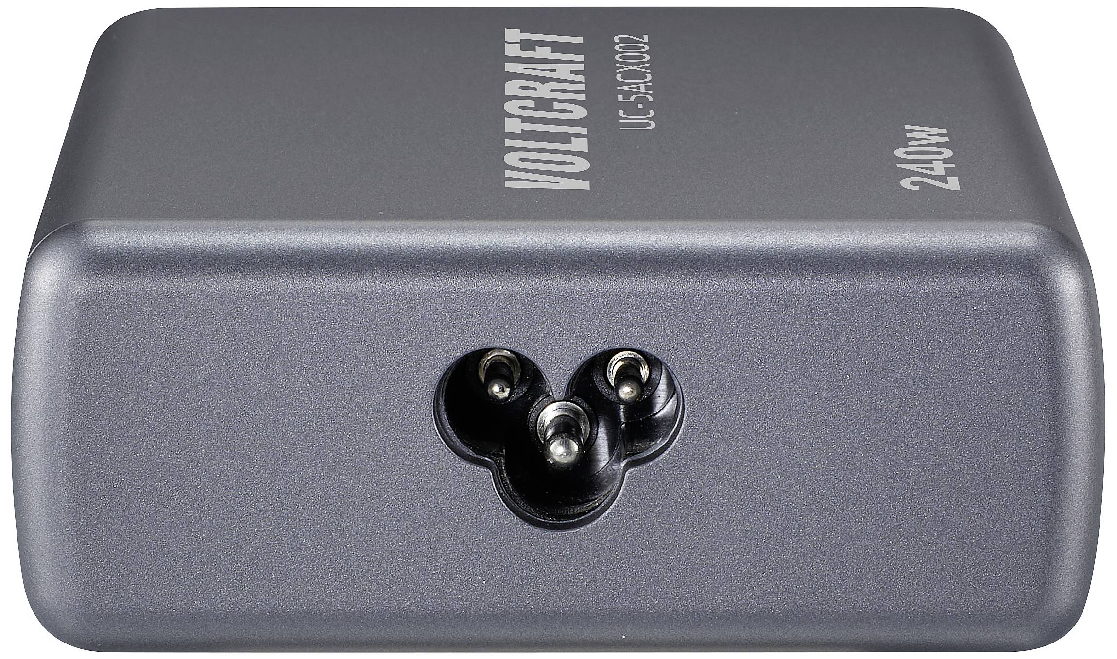 A grey, rectangular Voltcraft brand adapter, model UG-1AC1002, with a three-pin connection and '240W' inscription on the top surface.