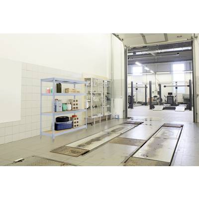 Large workshop with multiple vehicle hoists and a shelf on the left wall, on which various car care products are placed.