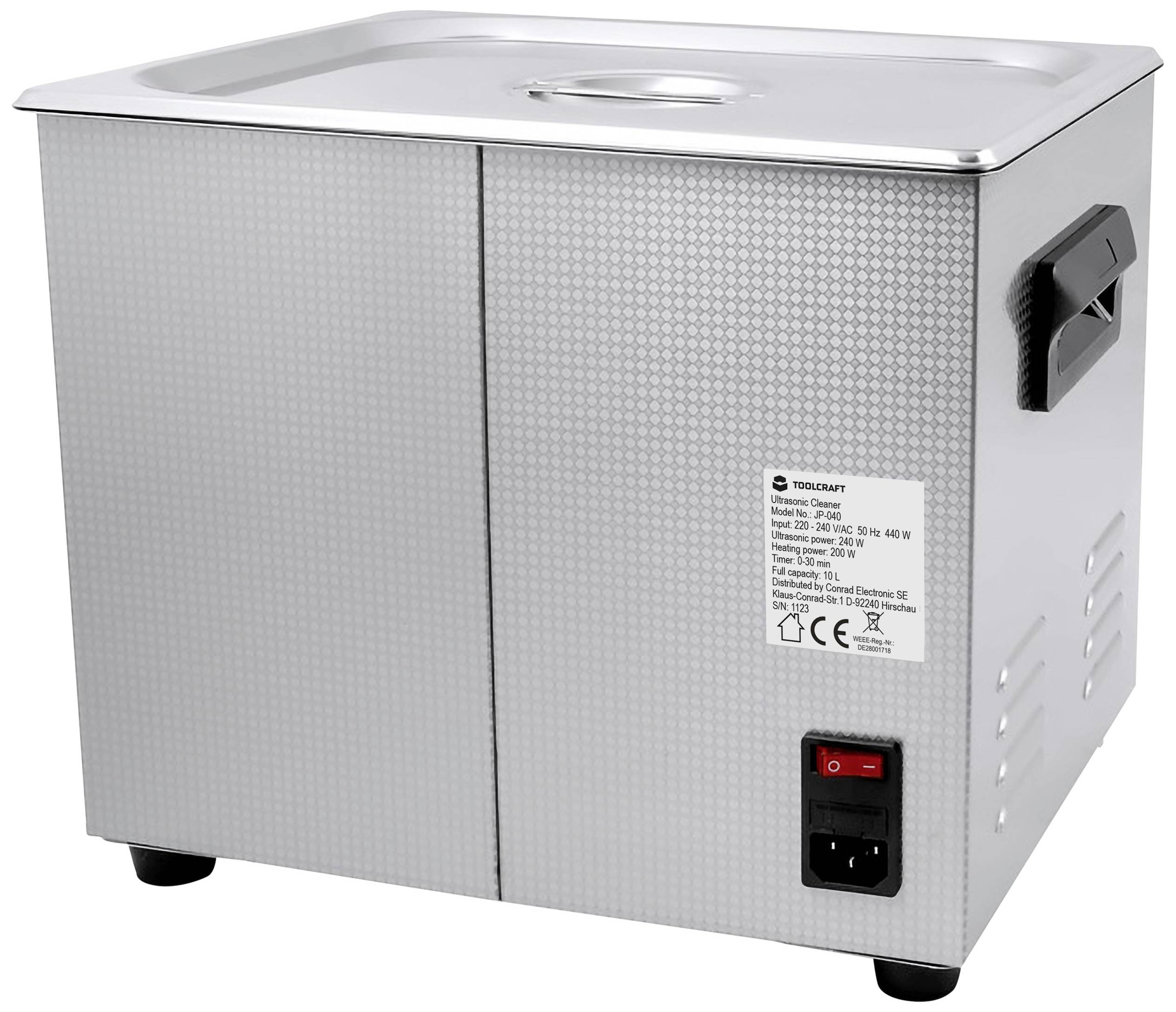 A silver ultrasonic cleaner with a lid, side handle, and switch. A label with technical specifications is attached to the side.