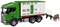 A green toy lorry with a trailer for livestock transport. A brown cow is standing behind the trailer, as if it were being loaded.