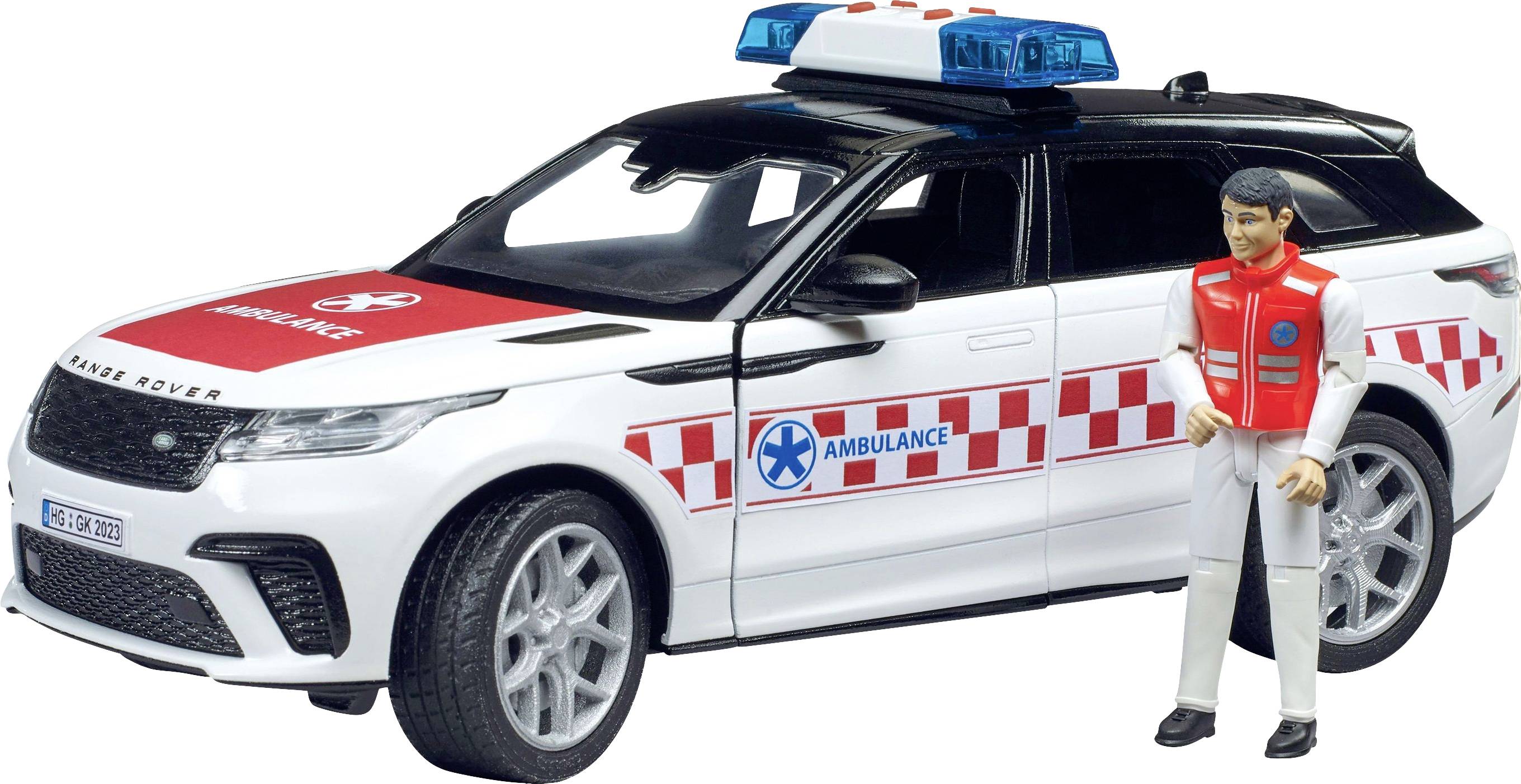 Toy ambulance with a figurine driver wearing a red rescue vest beside it. Vehicle in white with a red pattern and 'Ambulance' lettering.