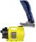 A yellow device with 'Kärcher' written on it. A foot in jeans and trainers appears to be standing on it without damaging the device.