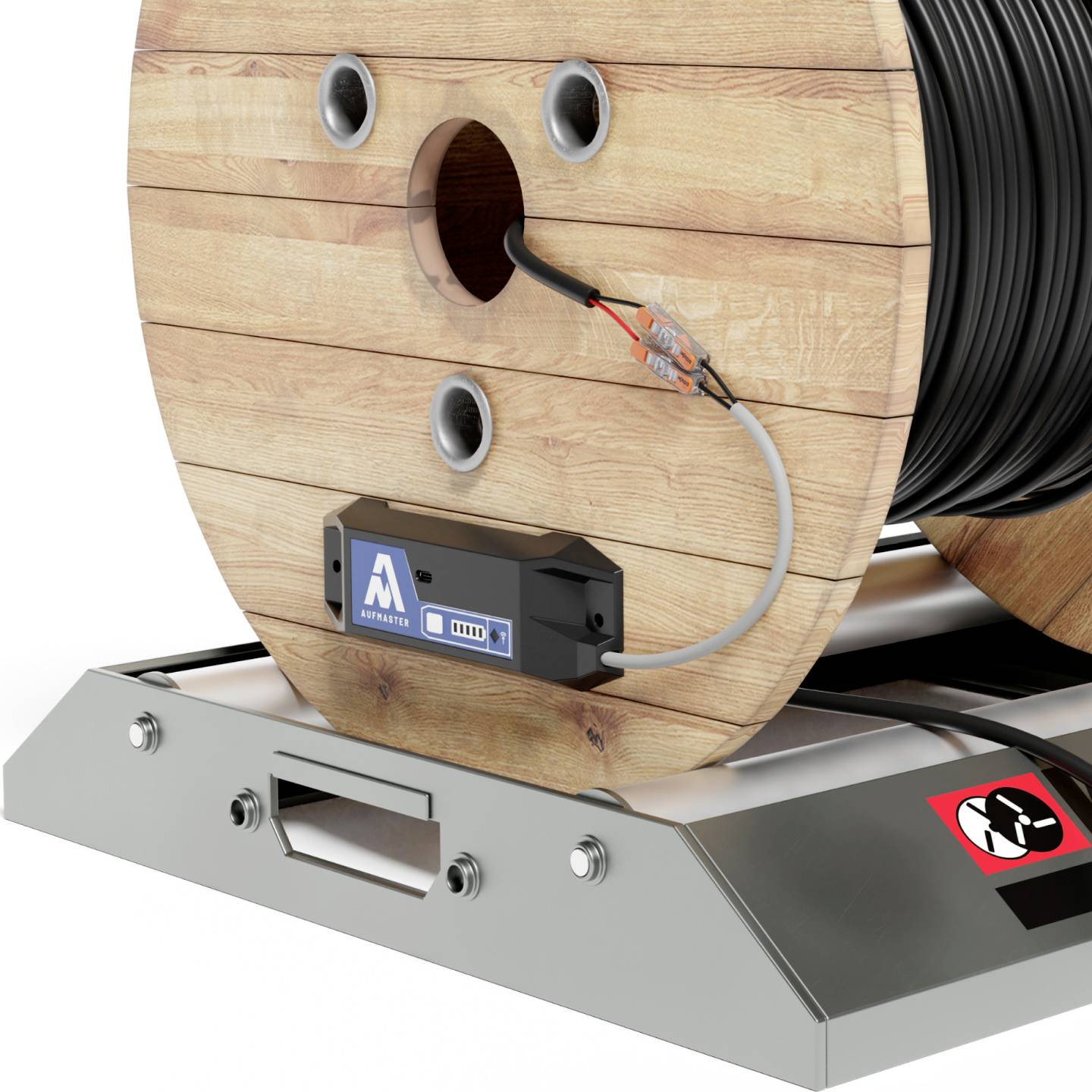 A large wooden reel with a black cable wound around it, mounted on a metal base. A blue label displays symbols and numbers.