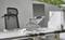 Modern desk with an ergonomic chair, laptop on a stand, folder holder, and stapler; ideal for productive working.