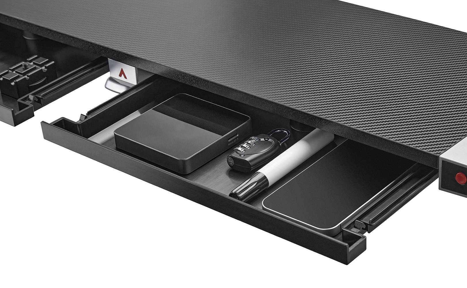 Desk with pull-out drawers, neatly storing accessories such as pens, a set of keys, and technical equipment.