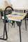 'Workbench with table saw, hose and accessories in workshop.'<br><br>Note: This is a direct translation to British English, maintaining the original structure and technical terminology.