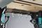 A workshop bench with multiple hooks underneath the worktop for hanging tools or accessories.