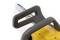 A portion of a yellow chainsaw is visible, including the handle and chain, resting on a white surface.