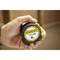 A hand is holding a yellow, round tape measure with the inscription 'STANLEY TYLON 5m'.