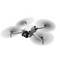 A white quadcopter drone hovers in the air. It has a camera on the front for aerial photography.