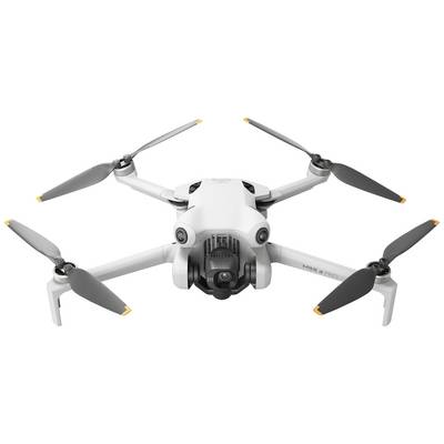 White drone with four rotors in flight, camera module visible at the front.