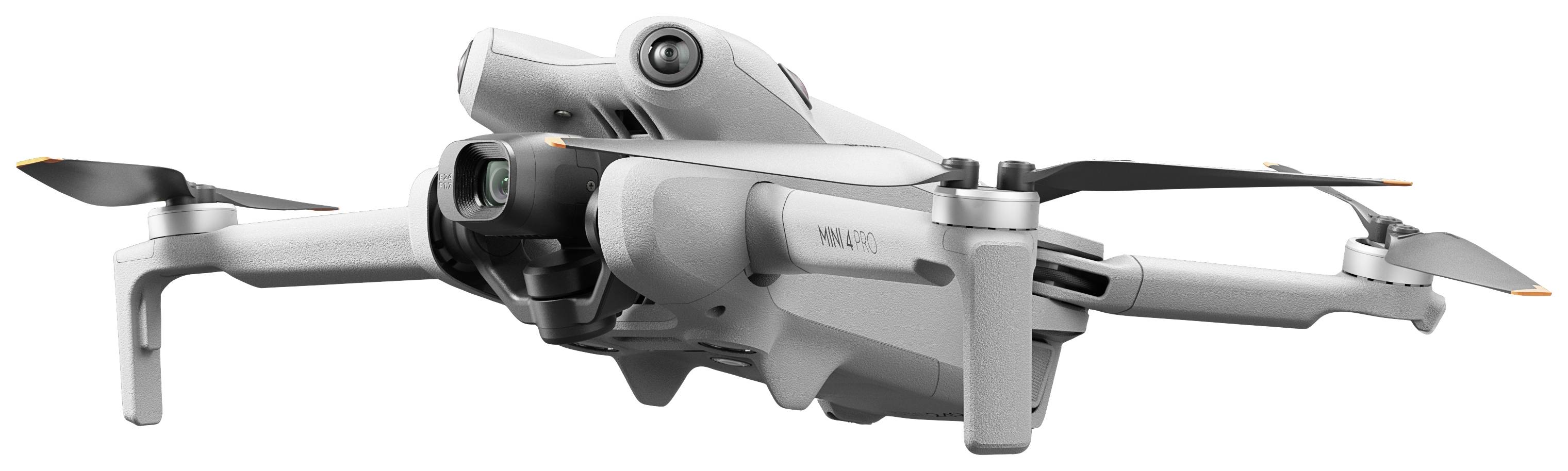 A grey drone with four propellers, elegant and compact in design, flies against a light background.