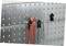 Metal hanging system with perforated pattern, with a red pliers attached to it.