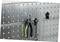 Tool wall with pliers and spanners, hung on hooks on a perforated metal board, organised for easy access.