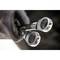 Close-up of two chrome spanners in a leather tool holder, revealing their gleaming surfaces and teeth.
