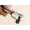 A hand is holding a gleaming chrome spanner with a black button, ready for use.<br><br>Note: In British English, "spanner" is used instead of "wrench", and the phrasing maintains the original descriptive and technical tone of the source text.