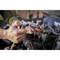 A person is holding a ratchet with a socket while working on a car part in the engine bay.