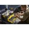 A person is repairing a car and is using a toolbox with open compartments, in which various tools are lying.
