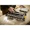 'A person is using a socket wrench set. Different nuts and a torque wrench are visible in an open case.'