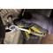 A gloved hand tightens a screw on a metal component using a spanner.