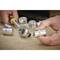 A hand is holding a socket wrench insert, with other tools in the background.