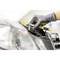 'A person is repairing a car with a spanner, wearing a grey glove and holding additional tools in their left hand.'