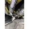 A mechanic is wearing gloves and repairing something with a spanner. Focus is on the hands and the tool.